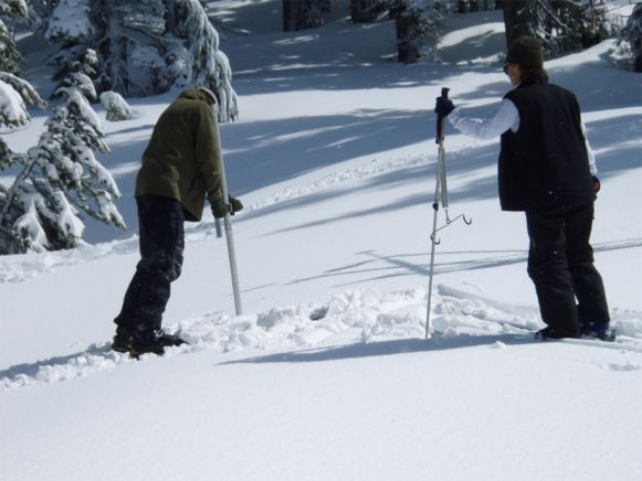 Preparing to weigh a column of snow.